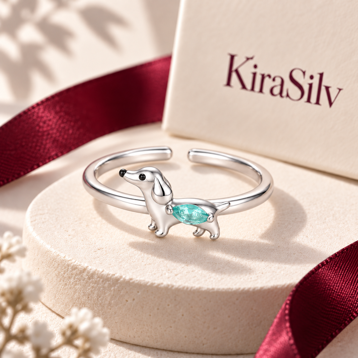 Dachshund crystal ring on a cream display with burgundy ribbon and KiraSilv packaging