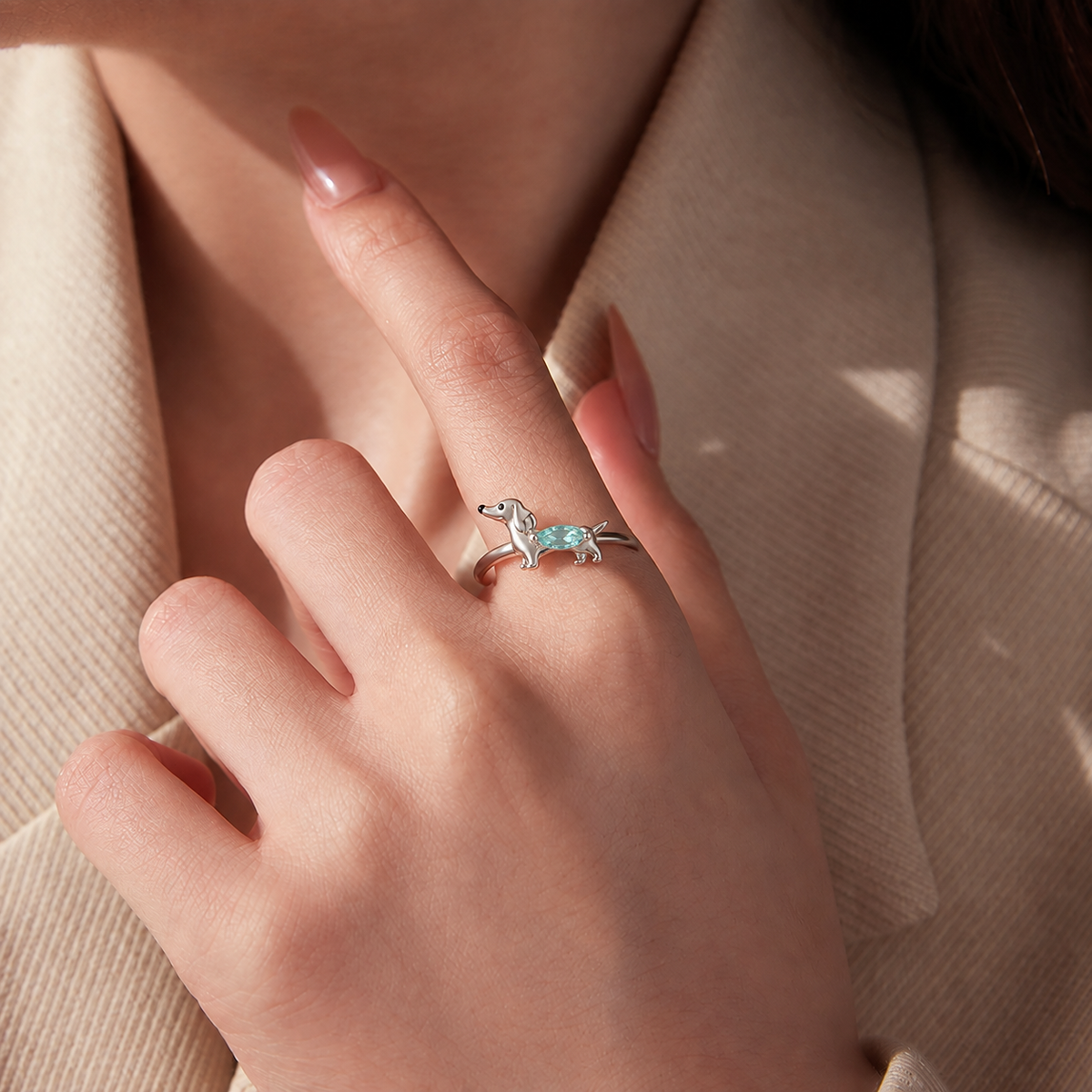 Dachshund crystal ring worn with a cream blazer